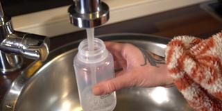 Eine Frau füllt eine Plastikflasche (Foto: SR)