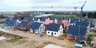 Zahlreiche Wohnhäuser und und Baustellen in einem Neubaugebiet (Foto: picture alliance/dpa | Julian Stratenschulte)