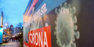 Abbildung eines Virus auf dem Banner eines Coronatestzentrums (Foto: picture alliance/dpa/dpa-Zentralbild | Sebastian Willnow)