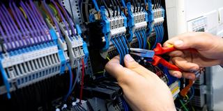 Ein Elektriker arbeitet an einem Schaltkasten (Foto: picture alliance/dpa | Sven Hoppe)
