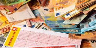Symbolbild Lottogewinn. Tippscheine liegen auf vielen Geldscheinen. (Foto: picture alliance / Geisler-Fotopress | Burkhard Schubert)