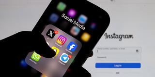 Der Anmeldebildschirm von Instagram wird auf einem Laptop-Bildschirm angezeigt, und der Social-Media-Ordner wird auf einem Smartphone-Bildschirm angezeigt. (Foto: picture alliance / Anadolu | Ismail Aslandag)