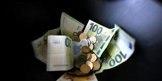 Münzen und Geldscheine vor einem schwarzen Hintergrund (Symbolbild) (Foto: picture alliance / HARALD SCHNEIDER / APA / picturedesk.com | HARALD SCHNEIDER)