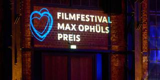 Das Logo des Filmfestivals Max Ophüls Preis ist auf eine Wand projiziert. (Foto: ffmop/Kullmann)