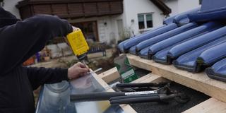 Ein Dachdecker befestigt ein Traufblech. (Foto: Imago/Zoonar/ErichTeister)