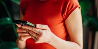 Eine Frau hält ein Smartphone in den Händen (Foto: IMAGO / Westend61)